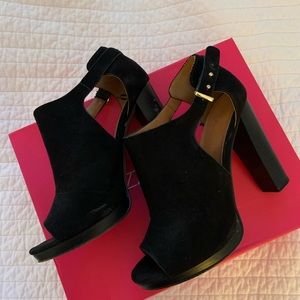 Black heels. Open toed.